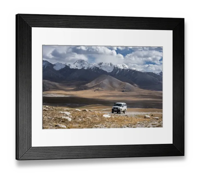 Framed Print : Off-road vehicle on a gravel track