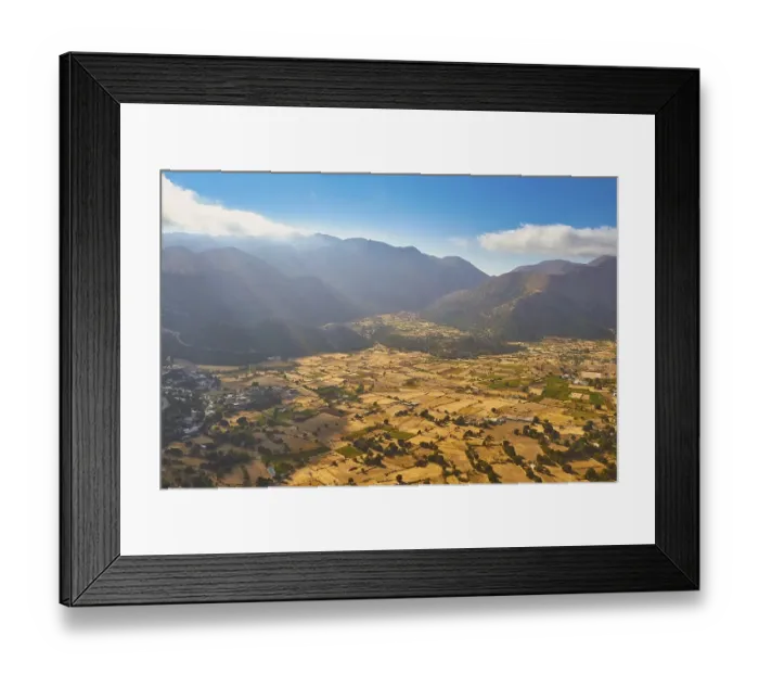 Framed Print : Wide fields and mountains under a clear sky with few clouds