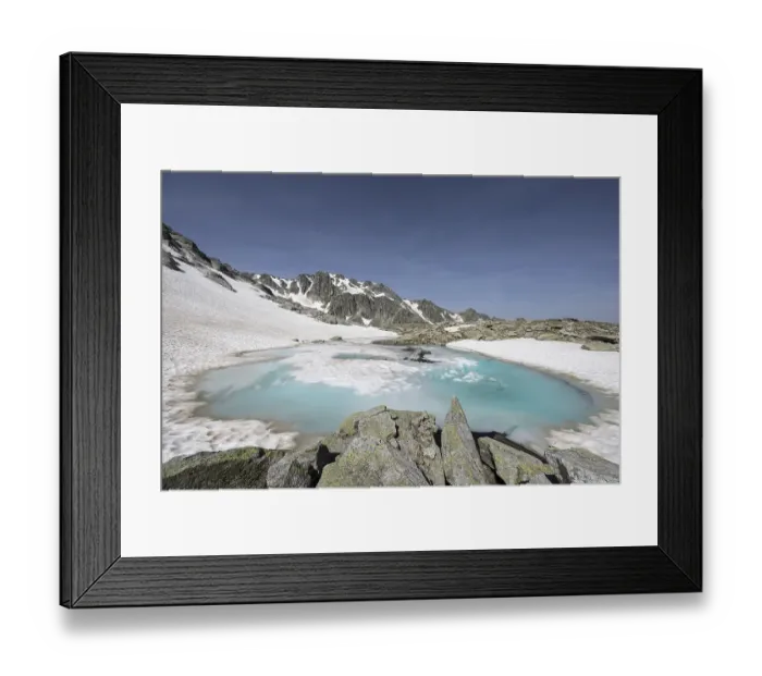 Framed Print : Frozen meltwater lake with snow-covered mountains in the background, Neukirchen am Grossvenediger, Salzburg, Austria, Europe