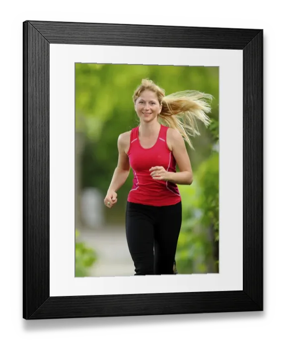 Framed Print : Young woman jogging