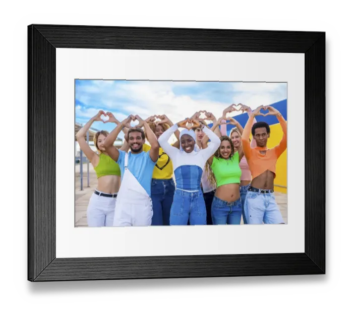 Framed Print : Multi-ethnic young people standing gesturing heart shape with hands outdoors in a urban space Framed Print : Multi-ethnic young people standing gesturing heart shape with hands outdoors in a urban space