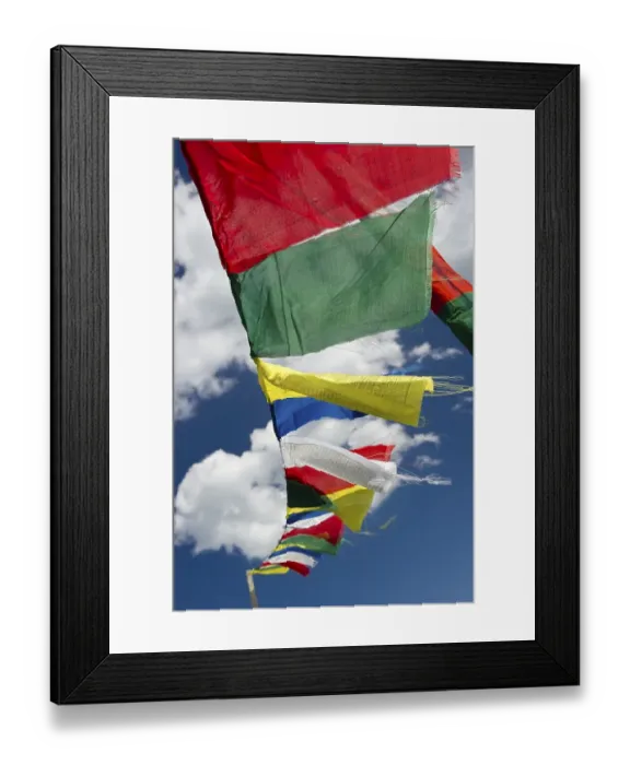 Framed Print : Tibetan prayer flags against a blue sky with clouds