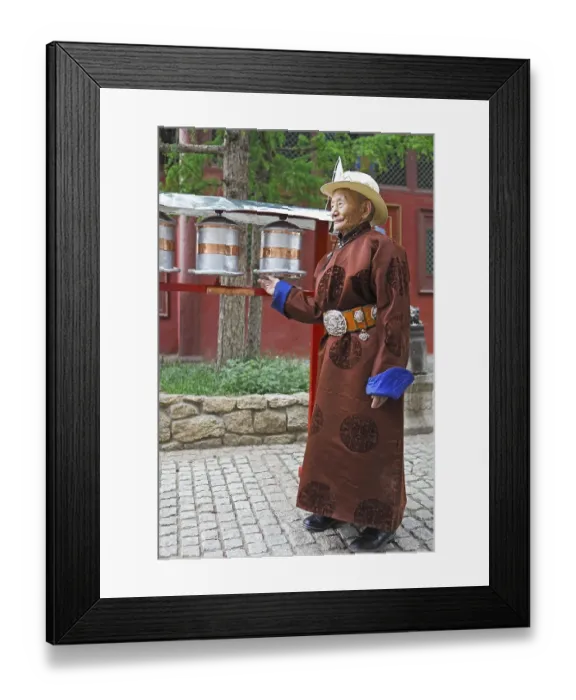 Framed Print : Elderly man wearing a traditional deel while rotating prayer wheels in the Buddhist Gandan Monastery, Ulaanbaatar, Mongolia, Asia