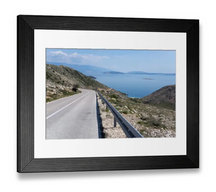 Framed Print : Winding road through mountainous landscape with sea view Framed Print : Winding road through mountainous landscape with sea view