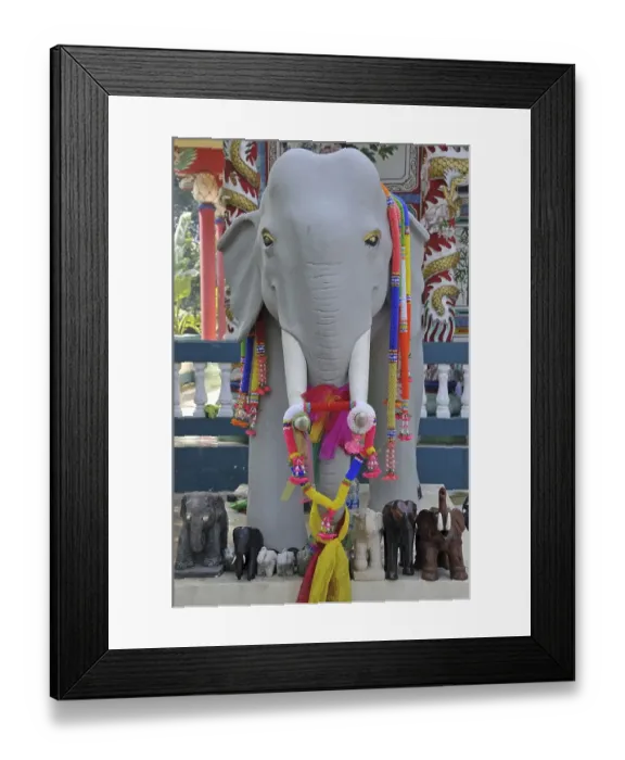 Framed Print : White elephant statue decorated in artificial flower garlands