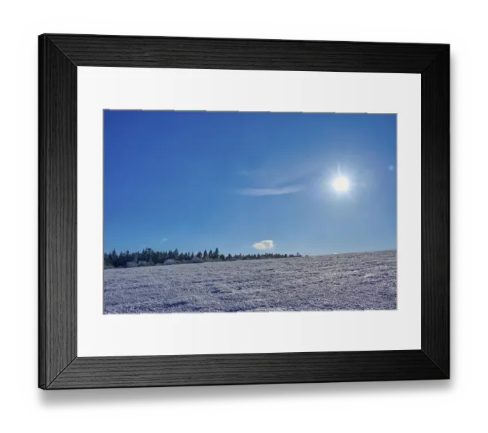 Framed Print : Wide expanse of snow under a clear blue sky with bright sun