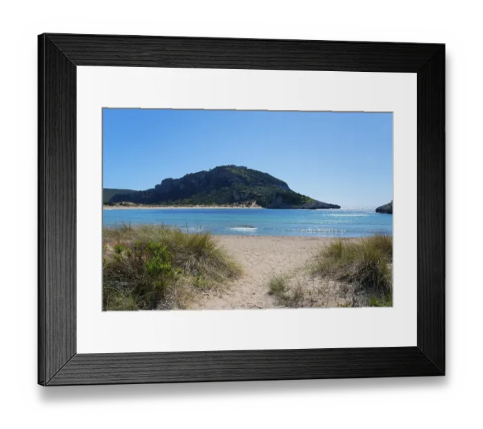 Framed Print : An idyllic beach with clear blue water and a mountain in the background on a sunny day Framed Print : An idyllic beach with clear blue water and a mountain in the background on a sunny day