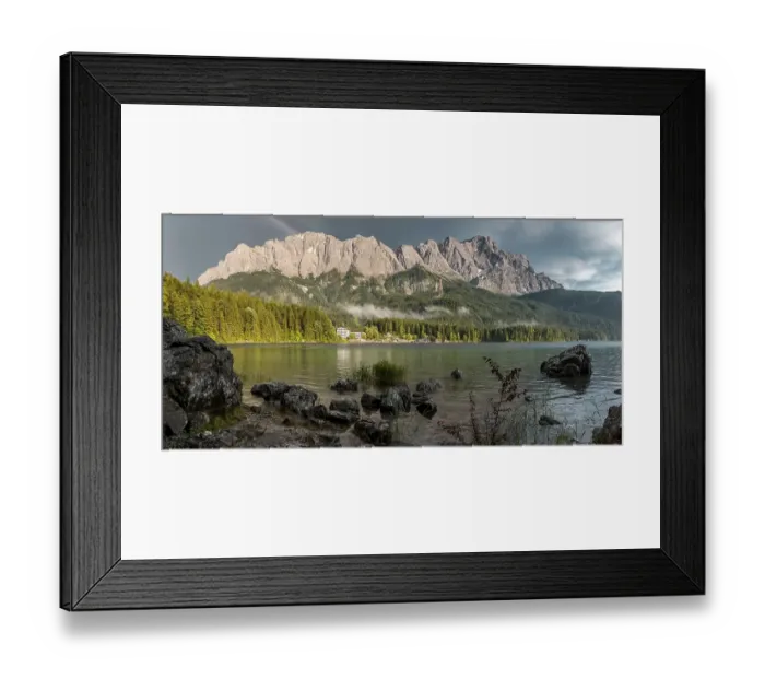Framed Print : Rocks on the shore, Eibsee lake in front of Zugspitze massif with Zugspitze with rainbow Framed Print : Rocks on the shore, Eibsee lake in front of Zugspitze massif with Zugspitze with rainbow
