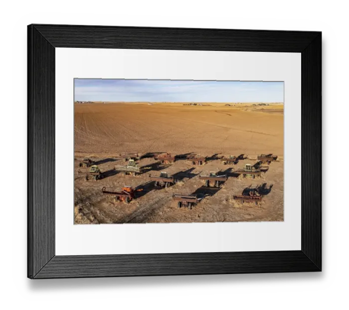 Framed Print : Canyon, Texas, Combine City, where a dozen old farm combines are partially buried in a field