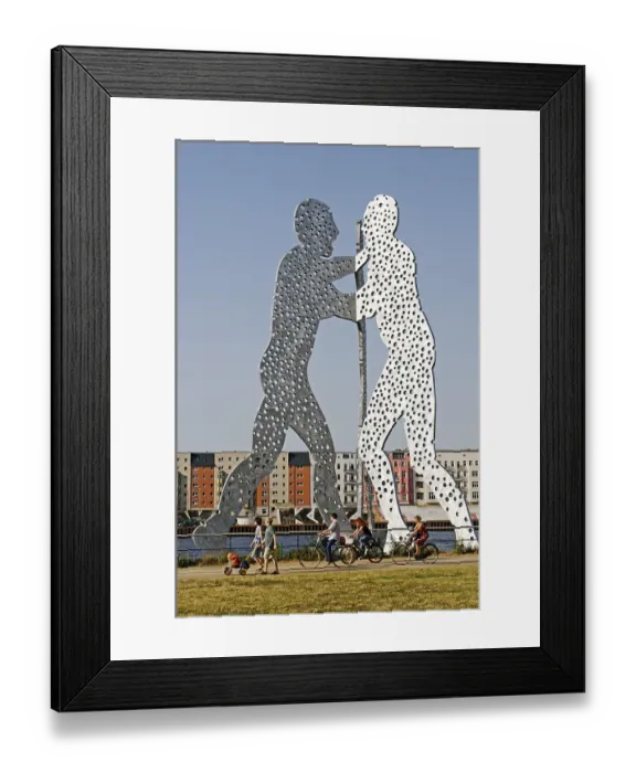 Framed Print : Cyclist in front of the Jonathan Borofsky's Molecule Man sculpture in the Spree River