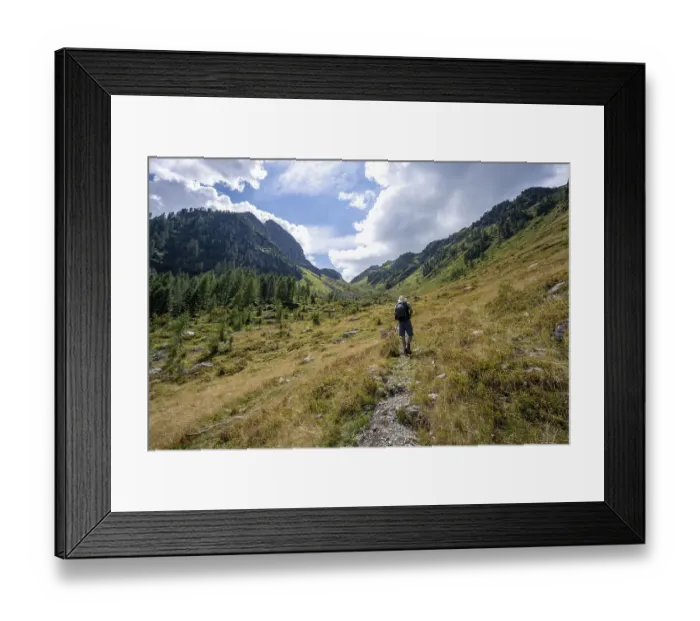 Framed Print : Mountaineer on a hiking trail, mountain landscape with green meadows