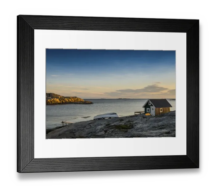 Framed Print : Fisherman's cottage by the sea at sunset