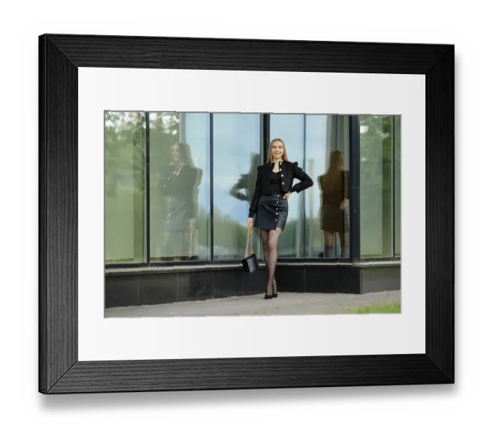 Framed Print : Happy young woman in black leather skirt and wool jacket standing by the building with large glass windows Framed Print : Happy young woman in black leather skirt and wool jacket standing by the building with large glass windows