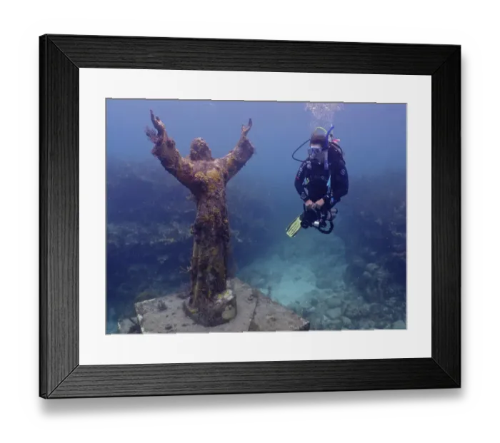 Framed Print : Diver looking at the statue of Jesus Christ underwater (Christ of the Abyss)