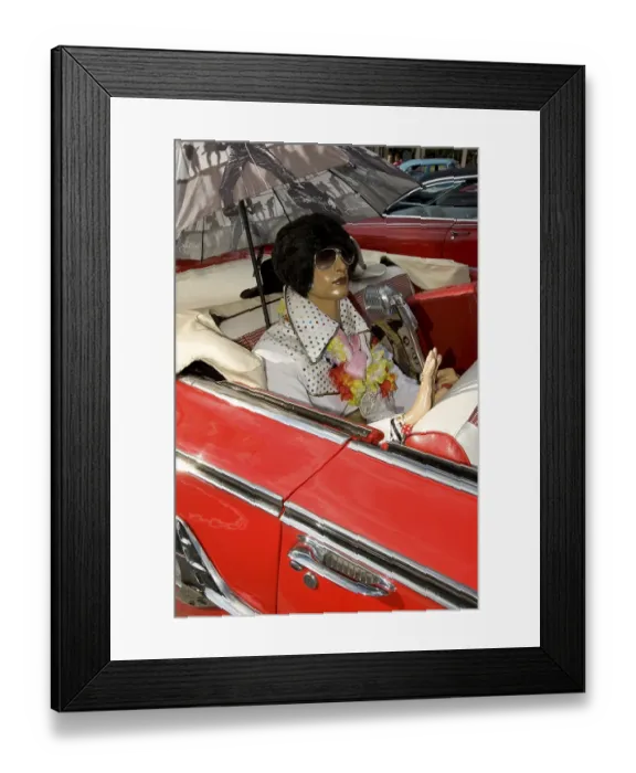 Framed Print : Elvis doll in the back seat of a red Cadillac Impala
