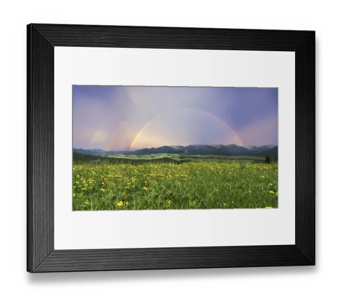 Framed Print : Rainbow over a landscape with a meadow and mountains Framed Print : Rainbow over a landscape with a meadow and mountains