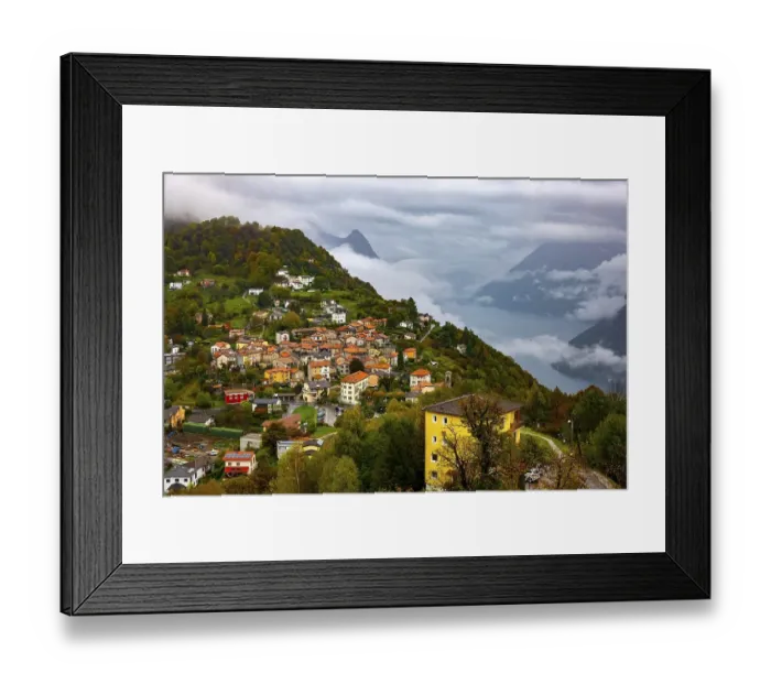 Framed Print : Aerial View over Mountainscape and Alpine Village Bre with Autumn Forest and Lake Lugano in a Cloudy Day in Monte Bre Framed Print : Aerial View over Mountainscape and Alpine Village Bre with Autumn Forest and Lake Lugano in a Cloudy Day in Monte Bre