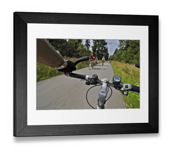 Framed Print : Cycle path with cyclists in Perlacher Forst forest