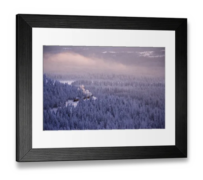 Framed Print : View from the Brocken mountain over a winter landscape deeply covered in snow at sunset and the Harzer Schmalspurbahn