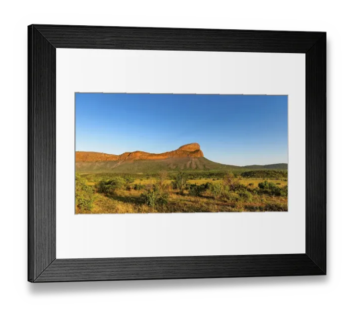Framed Print : Vast savannah landscape with a striking mountain under a clear blue sky