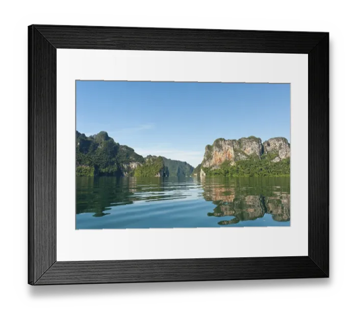 Framed Print : Forested karst limestone mountains reflected in the water