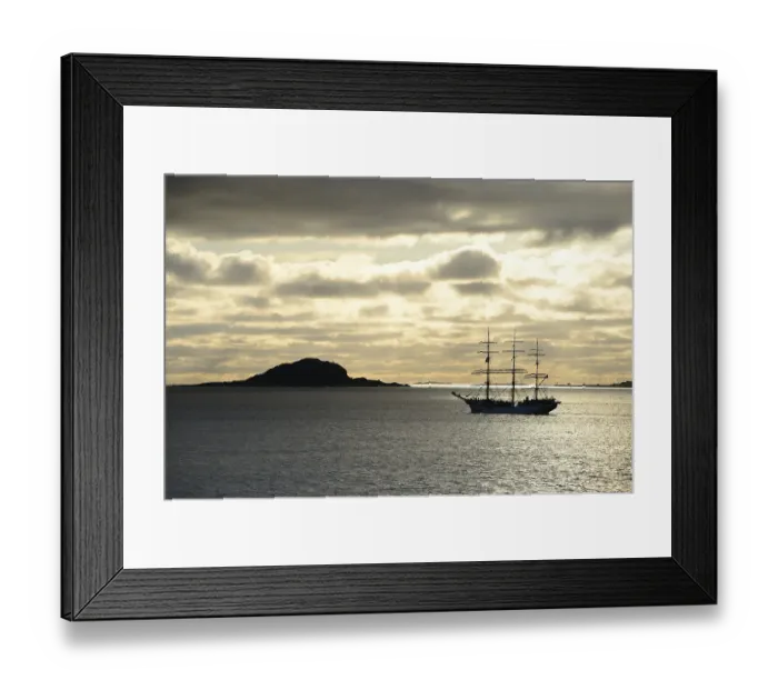 Framed Print : Ship sailing past an island at sunset Framed Print : Ship sailing past an island at sunset