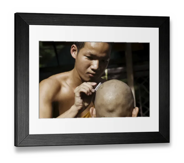 Framed Print : Young Buddhist monk having his head shaved with an old fashioned safety razor in Chiang Mai
