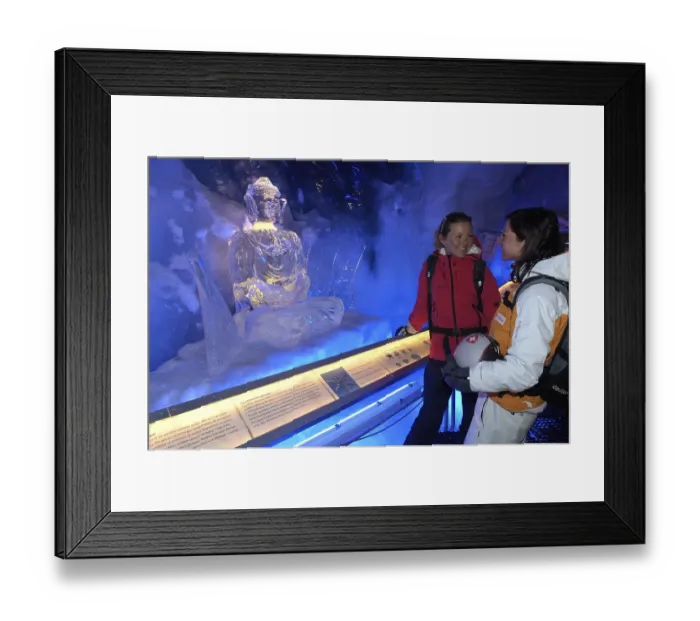 Framed Print : Ice Buddha statue admired by tourists in the ice cave in the Gletscherpalast or Glacier Palace