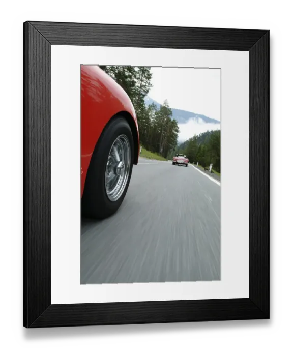 Framed Print : Red TR 3 driving behind a red vintage car
