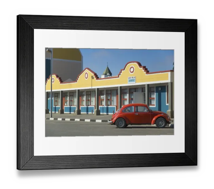 Framed Print : Red Volkswagen in front of a building in Swakopmund