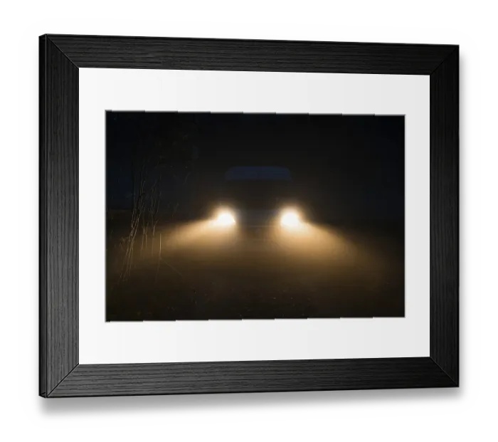 Framed Print : Campervan with bright lights standing in the fog