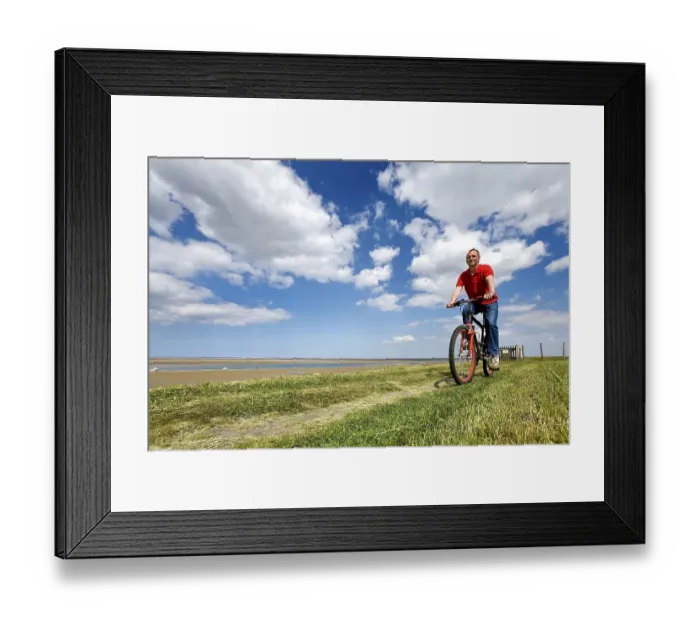Framed Print : Cyclist on a dike, Foehr, North Frisia