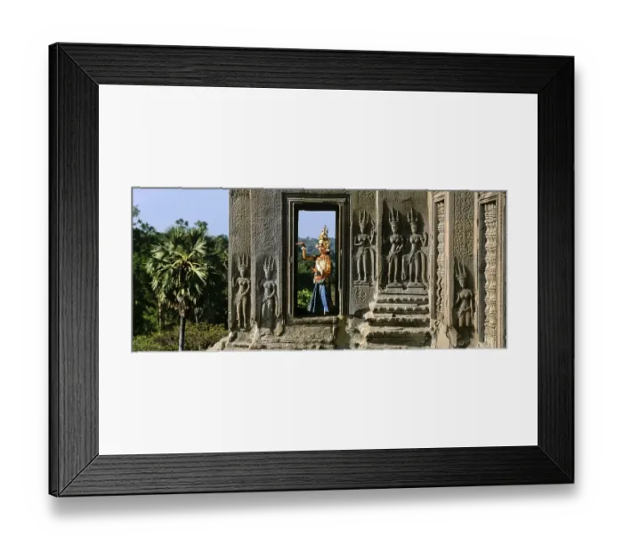 Framed Print : Temple dancer or apsara in a window of the temple of Angkor Wat beside apsara reliefs Framed Print : Temple dancer or apsara in a window of the temple of Angkor Wat beside apsara reliefs