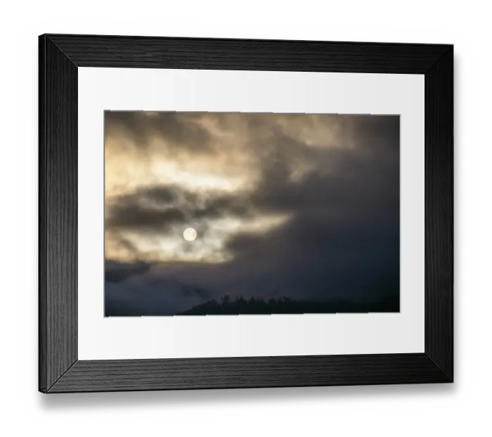 Framed Print : Sun above a mountain range breaking through morning clouds and fog Framed Print : Sun above a mountain range breaking through morning clouds and fog