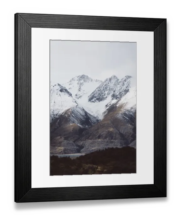 Framed Print : Snowy mountain landscape with clearly visible peaks under a cloudy sky Framed Print : Snowy mountain landscape with clearly visible peaks under a cloudy sky