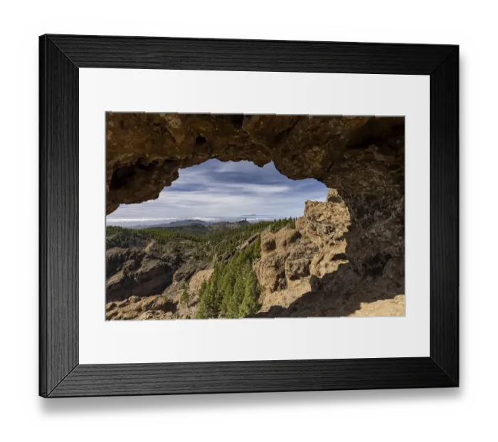 Framed Print : View through a rock arch to Roque Nublo and the Teide mountain peak on the neighbouring island of Tenerife Framed Print : View through a rock arch to Roque Nublo and the Teide mountain peak on the neighbouring island of Tenerife