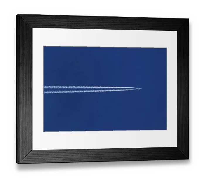 Framed Print : Double contrails behind airplane in the blue sky