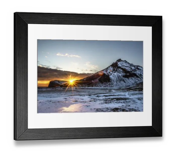 Framed Print : The sun rises behind snow-covered mountains and bathes the wintry landscape in warm light Framed Print : The sun rises behind snow-covered mountains and bathes the wintry landscape in warm light