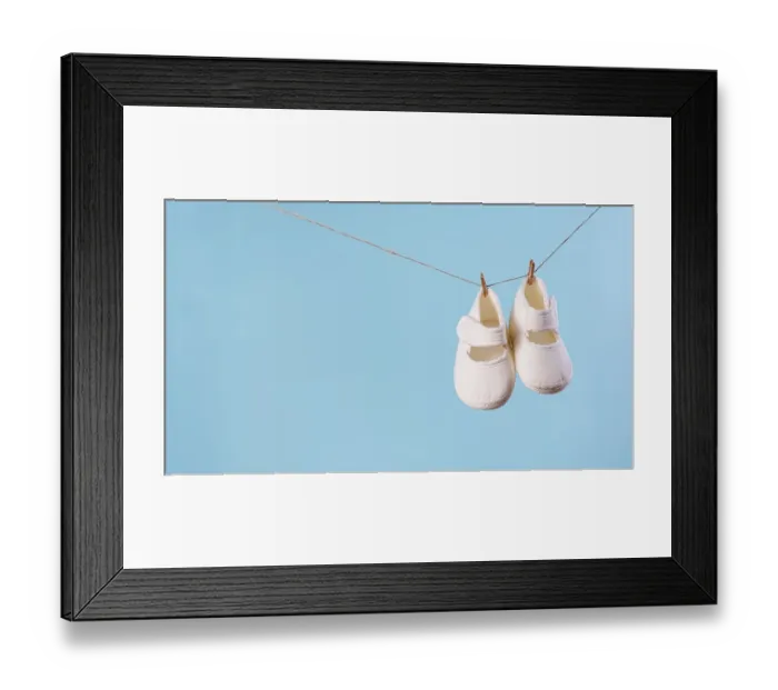 Framed Print : Front view cute little baby shoes with copy space