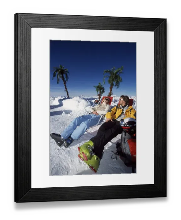 Framed Print : Two people in sunloungers in the montains in winter