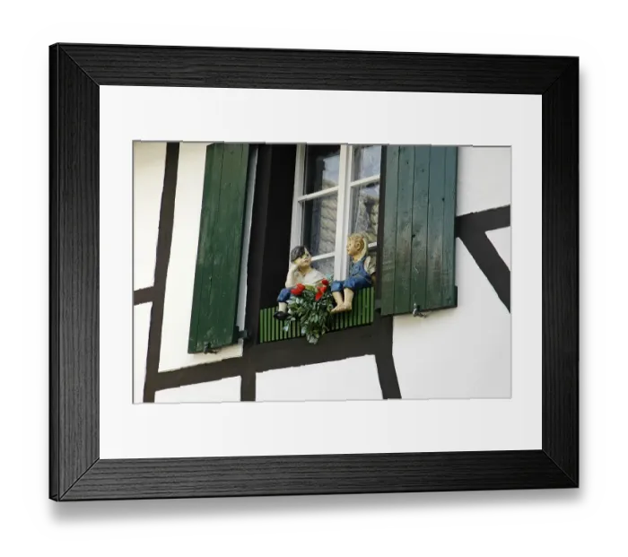 Framed Print : Figures of a boy and a girl in front of a window