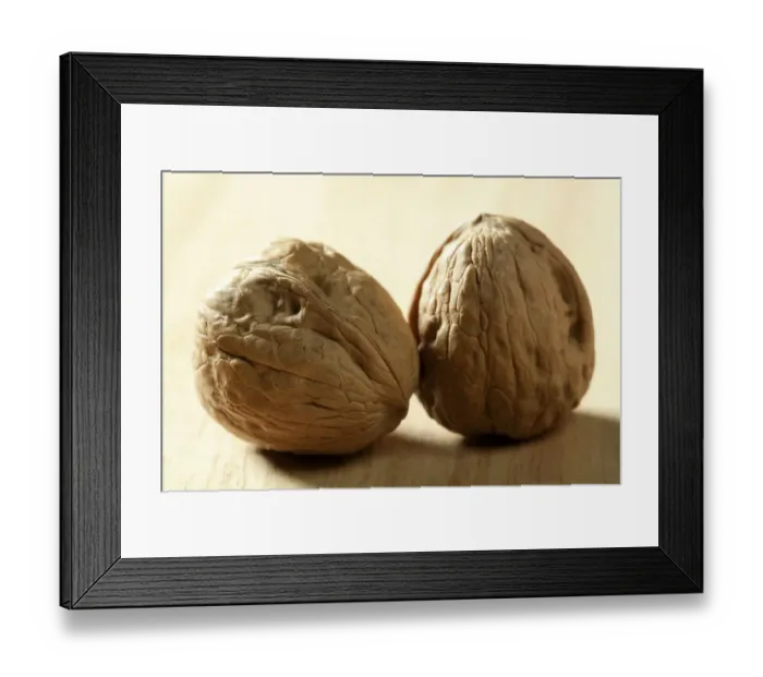 Framed Print : Two macro walnut with shells over maple wooden background Framed Print : Two macro walnut with shells over maple wooden background