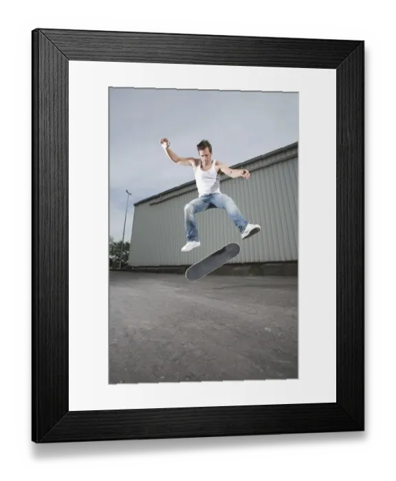 Framed Print : Skateboarder doing a flip trick