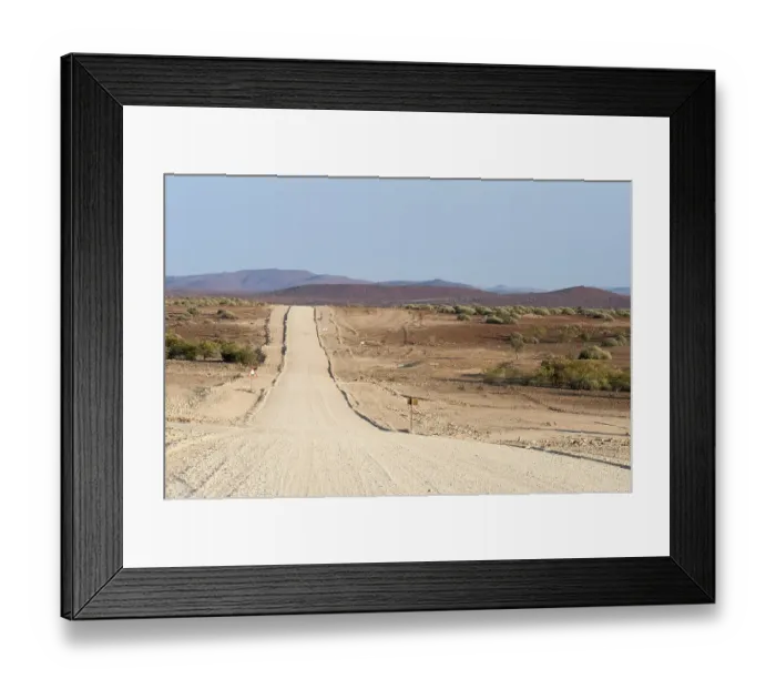 Framed Print : Wide, straight gravel road in dry landscape