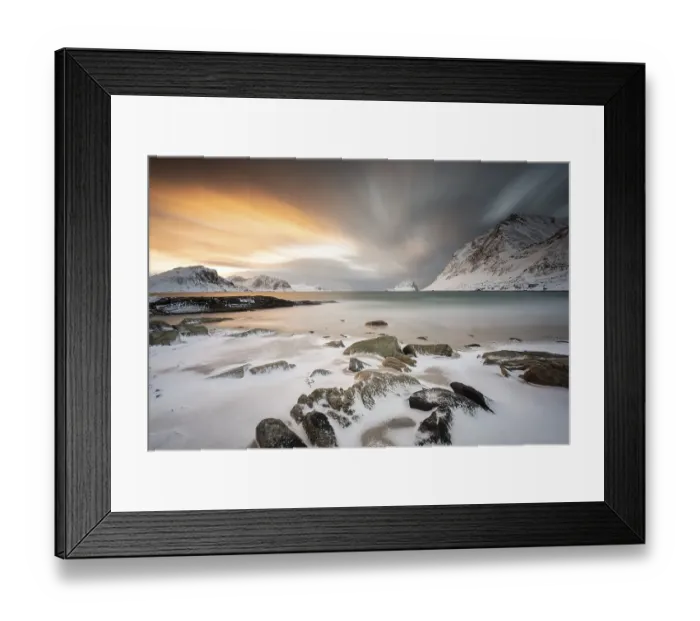 Framed Print : Rocky coast with snow at sunset