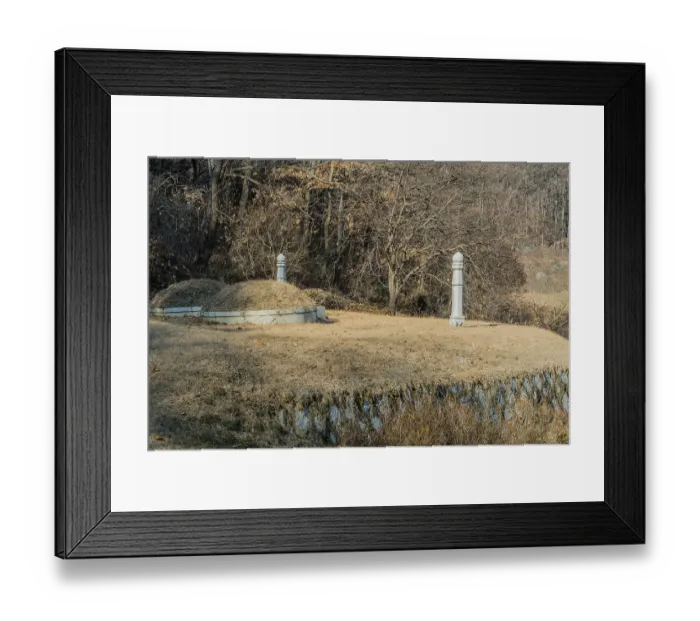Framed Print : Unmarked burial mounds on flat piece of land in wooded area on side of mountain on sunny winter day