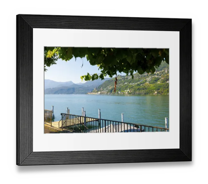 Framed Print : Lake and Mountain View with Tree Branch over Morcote in a Sunny Summer Day on Lake Lugano in Morcote