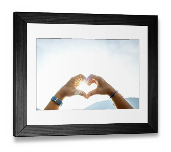 Framed Print : Woman Hands Making a Heart Shape Against the Sky with Sun and Sunbeam and Mountain in Switzerland