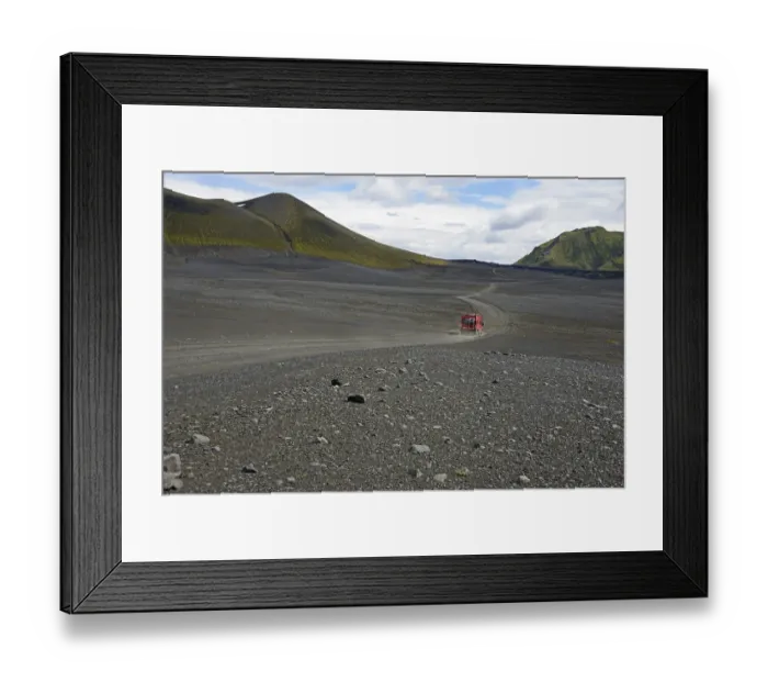 Framed Print : Caravan on dirt road in barren volcanic landscape