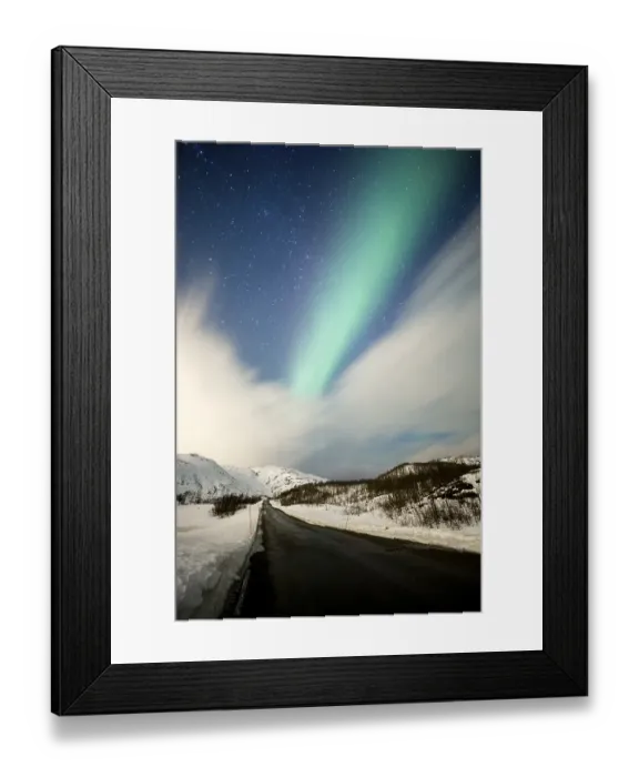 Framed Print : Northern lights over road with snow mountains